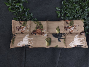 Körnerkissen mit Pferden und Heuballen im Vordergrund